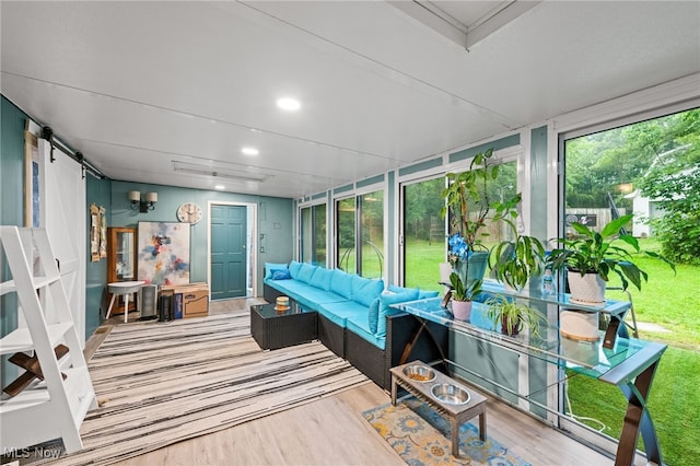 8902 Taylor May Rd, Chagrin Falls, OH 44023 - sunroom / solarium with wood finished floors, recessed lighting, a barn door, and a wooden deck