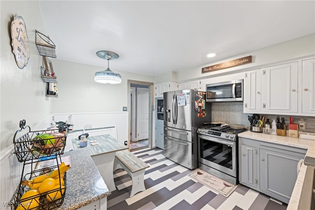 8902 Taylor May Rd, Chagrin Falls, OH 44023 - kitchen with appliances with stainless steel finishes, light floors, tasteful backsplash, and light stone counters