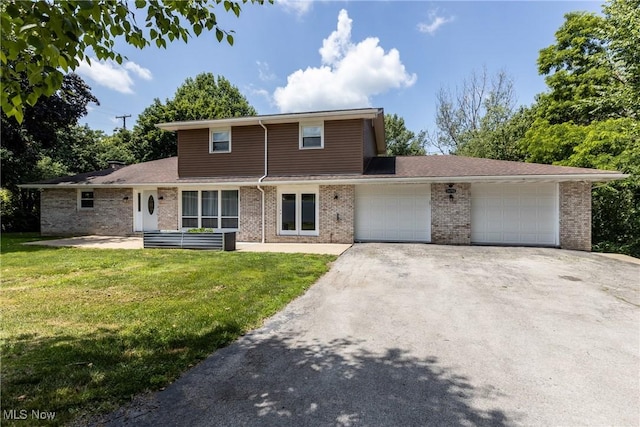 16792 Gonzales Ave, East Liverpool, OH 43920 - view of front facade featuring asphalt driveway, a front lawn, an attached garage, and brick siding