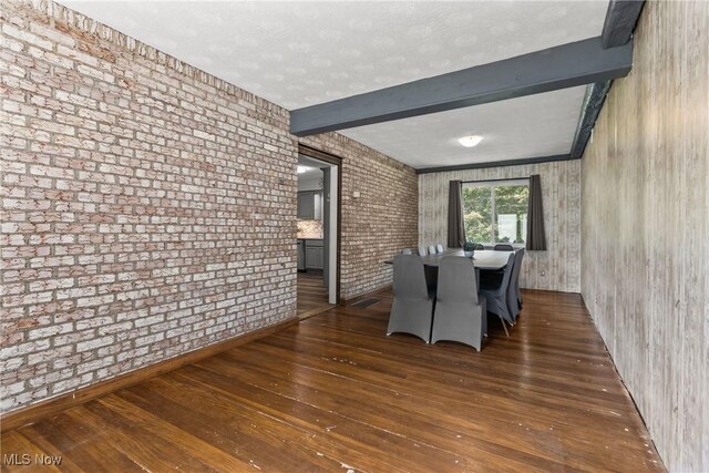 16792 Gonzales Ave, East Liverpool, OH 43920 - dining space featuring hardwood / wood-style flooring, beam ceiling, and brick wall