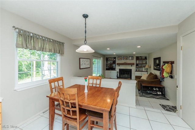 14344 S Gateway Dr, North Royalton, OH 44133 - dining area with a glass covered fireplace, light tile patterned flooring, and recessed lighting