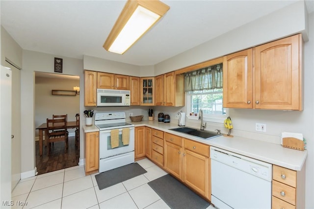 14344 S Gateway Dr, North Royalton, OH 44133 - kitchen with white appliances, light countertops, glass insert cabinets, and light tile patterned flooring