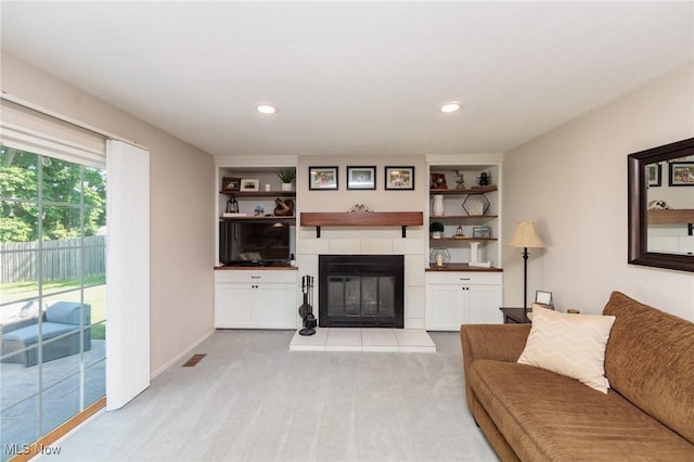 14344 S Gateway Dr, North Royalton, OH 44133 - living area featuring a tile fireplace, light carpet, built in shelves, and recessed lighting
