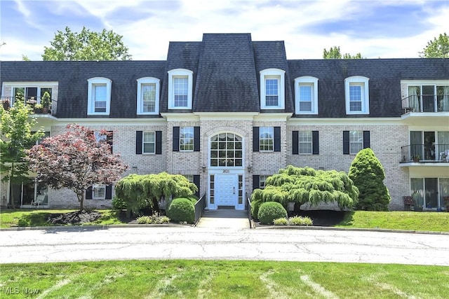 2021 King James Pkwy Unit 228, Westlake, OH 44145 - view of front of house featuring mansard roof, brick siding, and a shingled roof