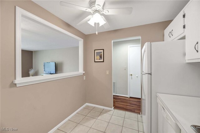 2021 King James Pkwy Unit 228, Westlake, OH 44145 - kitchen featuring white cabinetry, light countertops, ceiling fan, light tile patterned flooring, and freestanding refrigerator
