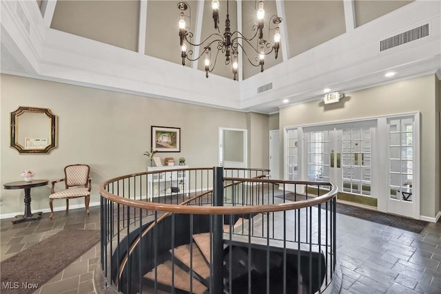 2021 King James Pkwy Unit 228, Westlake, OH 44145 - stairway featuring a high ceiling, a chandelier, stone tile flooring, and recessed lighting