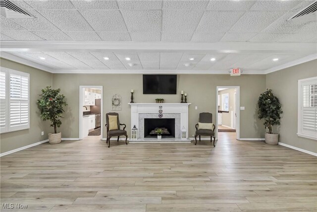 2021 King James Pkwy Unit 228, Westlake, OH 44145 - living area featuring light wood-style flooring, crown molding, recessed lighting, healthy amount of natural light, and a premium fireplace