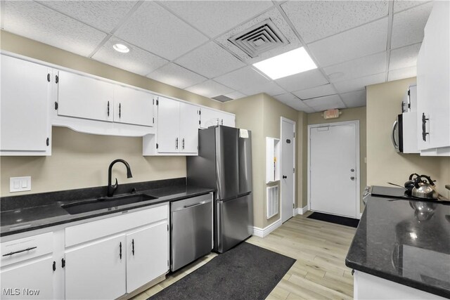 2021 King James Pkwy Unit 228, Westlake, OH 44145 - kitchen with stainless steel appliances, white cabinetry, and a paneled ceiling