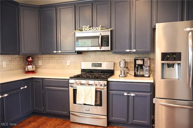 7509 Galena Ave NW, Canal Fulton, OH 44614 - kitchen featuring stainless steel appliances, light countertops, tasteful backsplash, and dark wood-style flooring