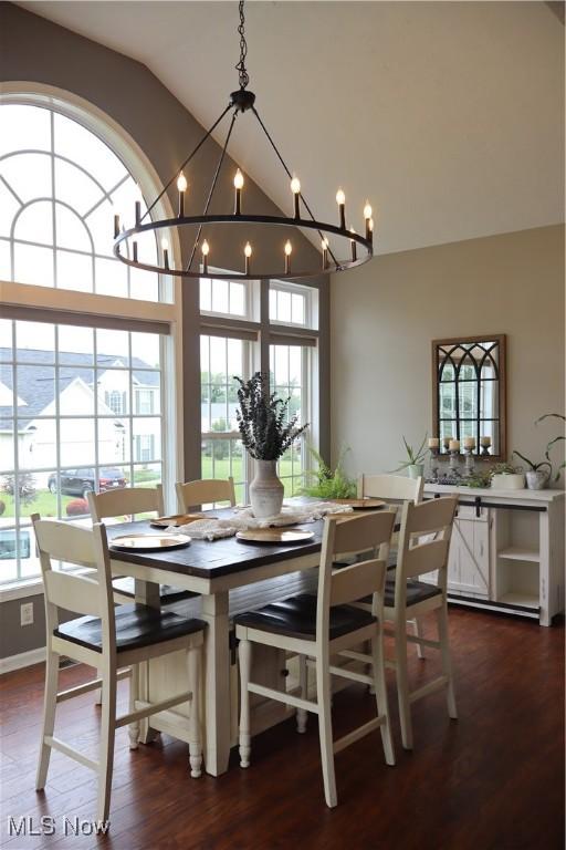 7509 Galena Ave NW, Canal Fulton, OH 44614 - dining area with a chandelier, lofted ceiling, healthy amount of natural light, and dark wood-style floors