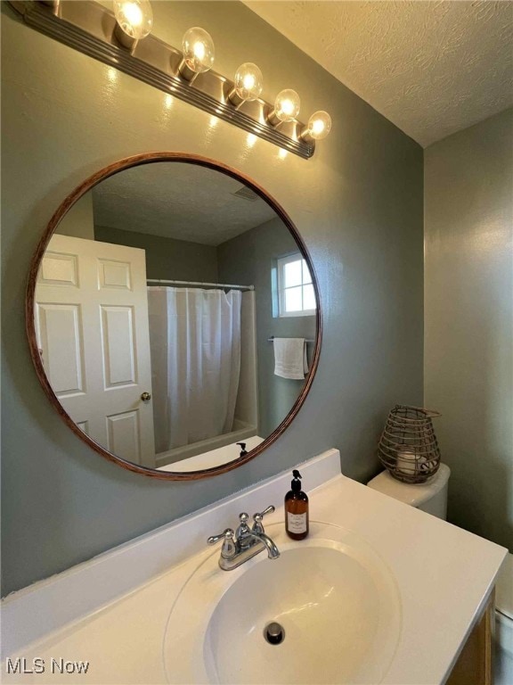 7509 Galena Ave NW, Canal Fulton, OH 44614 - bathroom with a textured ceiling and vanity