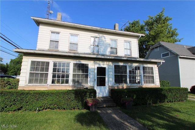 214 Fulton St, Port Clinton, OH 43452 - view of front of home with entry steps and a front yard