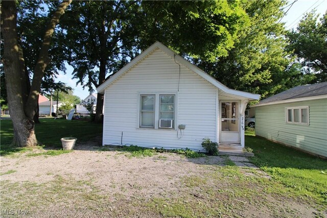 214 Fulton St, Port Clinton, OH 43452 - view of front facade featuring a front lawn and cooling unit