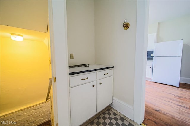 3006 6th St SW, Canton, OH 44710 - kitchen with freestanding refrigerator, white cabinets, and dark countertops