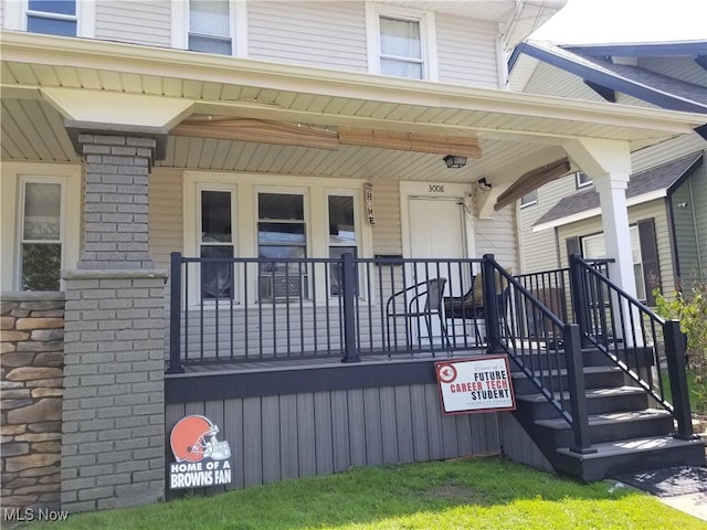 3006 6th St SW, Canton, OH 44710 - property entrance featuring covered porch and stone siding