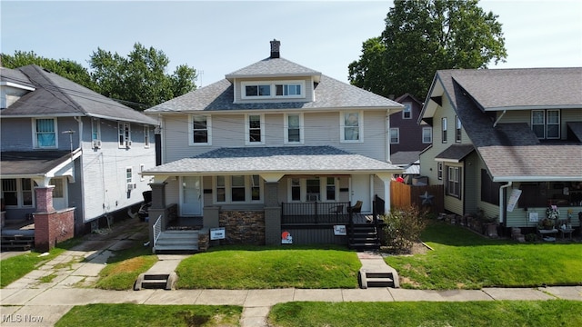 3006 6th St SW, Canton, OH 44710 - american foursquare style home with covered porch, a front lawn, and a shingled roof