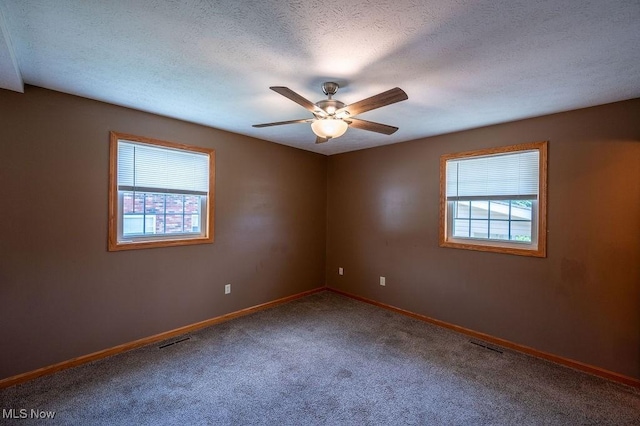 1565 Lois St, Belpre, OH 45714 - spare room featuring healthy amount of natural light, carpet floors, ceiling fan, and a textured ceiling