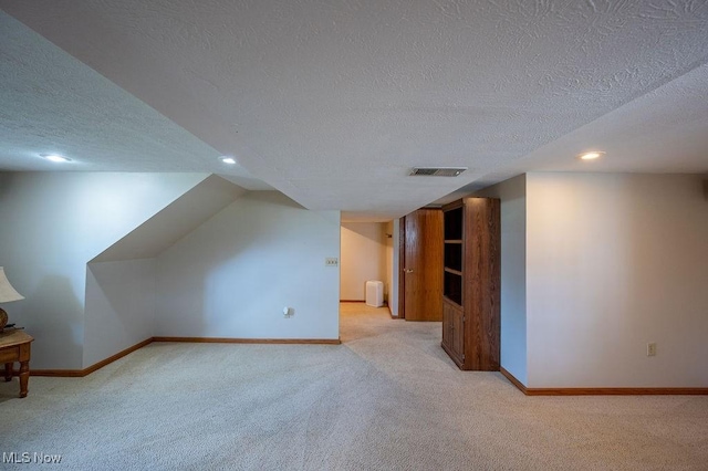 1565 Lois St, Belpre, OH 45714 - additional living space featuring light carpet, a textured ceiling, and recessed lighting