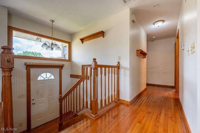 1565 Lois St, Belpre, OH 45714 - foyer with light wood-style flooring and a chandelier
