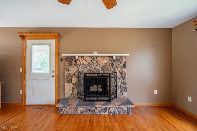 1565 Lois St, Belpre, OH 45714 - detailed view of wood finished floors, ceiling fan, and a fireplace