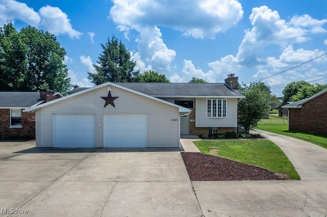 1565 Lois St, Belpre, OH 45714 - tri-level home with a garage, a chimney, a front lawn, and brick siding