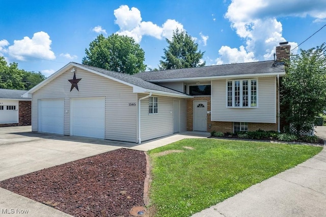 1565 Lois St, Belpre, OH 45714 - split level home with a front lawn, a chimney, and a garage