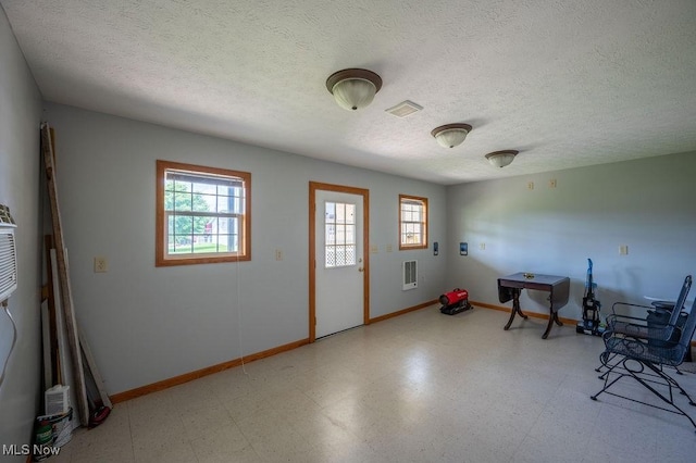 1565 Lois St, Belpre, OH 45714 - misc room with plenty of natural light, tile patterned floors, and a textured ceiling