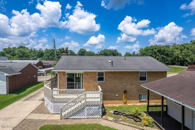 1565 Lois St, Belpre, OH 45714 - rear view of property with brick siding, concrete driveway, and roof with shingles