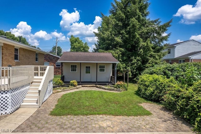 1565 Lois St, Belpre, OH 45714 - view of front of property with a front yard, an outdoor structure, stairway, and a deck