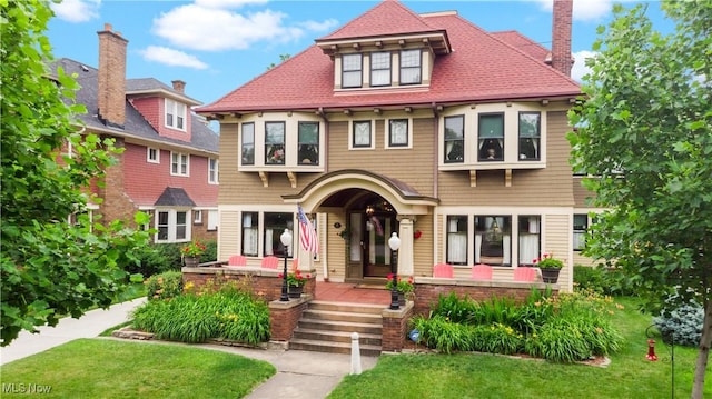 10921 Wade Park Ave, Cleveland, OH 44106 - victorian house featuring a front lawn, a chimney, and a porch