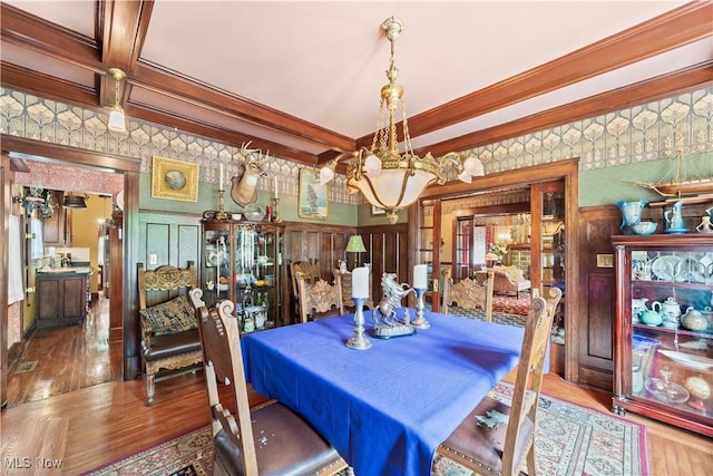 10921 Wade Park Ave, Cleveland, OH 44106 - dining space with wood finished floors, a chandelier, crown molding, and beamed ceiling