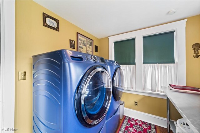 10921 Wade Park Ave, Cleveland, OH 44106 - laundry area with independent washer and dryer and baseboards