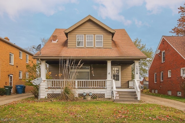 7508 Theota Ave, Parma, OH 44129 - bungalow featuring a porch and a front yard