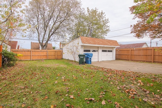7508 Theota Ave, Parma, OH 44129 - fenced backyard featuring a garage and an outbuilding