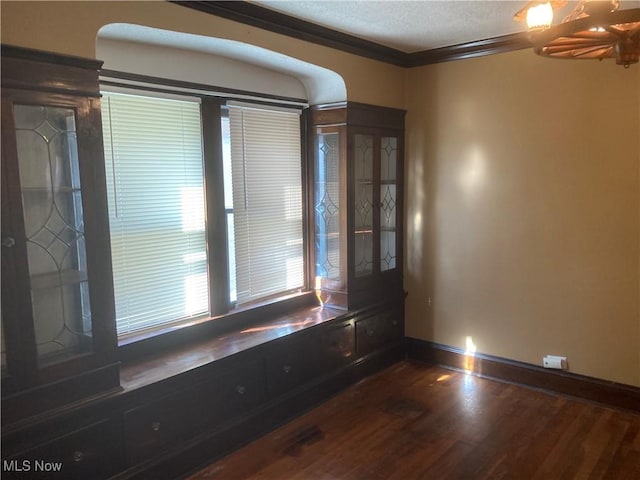 7508 Theota Ave, Parma, OH 44129 - unfurnished room with dark wood-style floors, a textured ceiling, arched walkways, ceiling fan, and ornamental molding