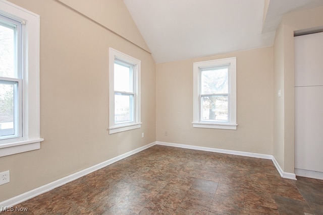 7508 Theota Ave, Parma, OH 44129 - unfurnished room featuring stone finish flooring and lofted ceiling