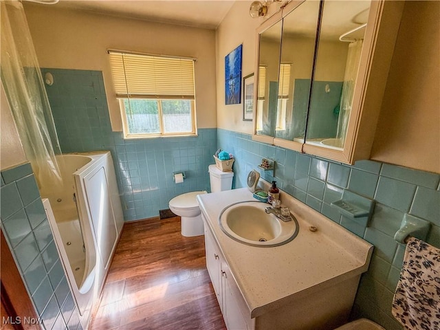 7328 S Calhoun Hwy, Mount Zion, WV 26151 - bathroom with tile walls, a bath, wood finished floors, vanity, and a shower with curtain