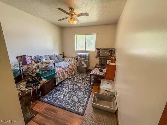 7328 S Calhoun Hwy, Mount Zion, WV 26151 - bedroom with wood finished floors, a textured ceiling, and ceiling fan