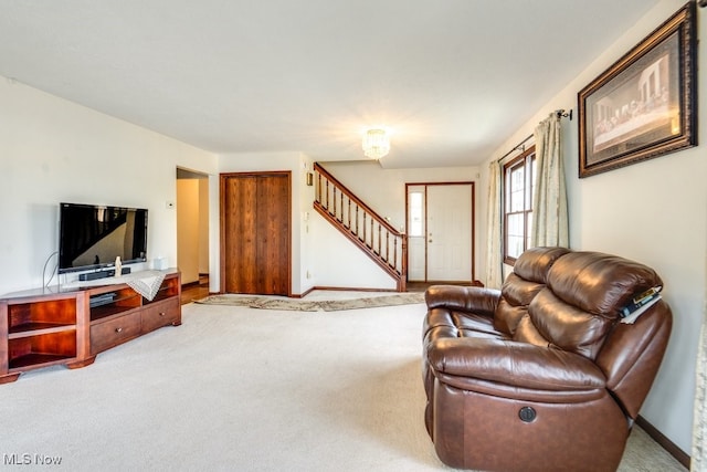 3613 Peninsula Dr, Akron, OH 44319 - carpeted living room featuring stairs and baseboards
