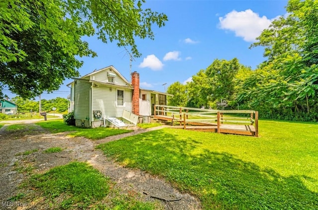 1016 W 55th St, Ashtabula, OH 44004 - back of property featuring a chimney and a lawn