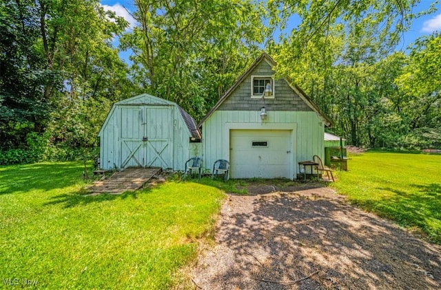 1016 W 55th St, Ashtabula, OH 44004 - detached garage featuring driveway and a shed