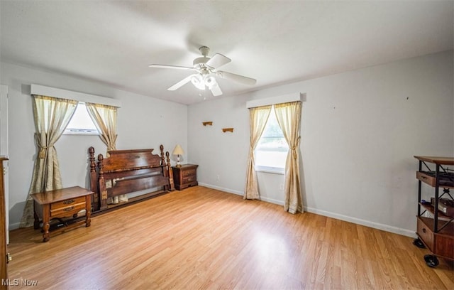 1016 W 55th St, Ashtabula, OH 44004 - bedroom with multiple windows, light wood-style floors, and a ceiling fan
