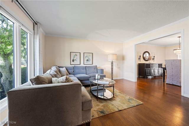 195 Sleepy Hollow Dr, Amherst, OH 44001 - living room featuring ornamental molding, wood finished floors, and a chandelier