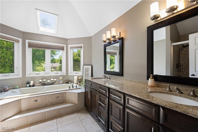 195 Sleepy Hollow Dr, Amherst, OH 44001 - full bath featuring lofted ceiling, double vanity, a bath, tile patterned floors, and a shower stall