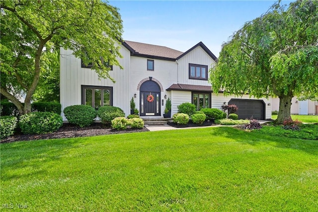 195 Sleepy Hollow Dr, Amherst, OH 44001 - modern farmhouse style home featuring a front lawn, a garage, and board and batten siding