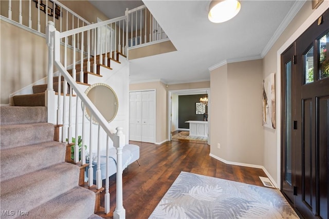 195 Sleepy Hollow Dr, Amherst, OH 44001 - entrance foyer with stairs, wood finished floors, crown molding, and a chandelier