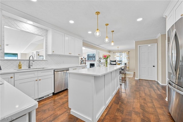 195 Sleepy Hollow Dr, Amherst, OH 44001 - kitchen featuring appliances with stainless steel finishes, tasteful backsplash, white cabinetry, recessed lighting, and crown molding
