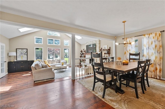 195 Sleepy Hollow Dr, Amherst, OH 44001 - dining area with lofted ceiling, dark wood finished floors, ornamental molding, and a chandelier