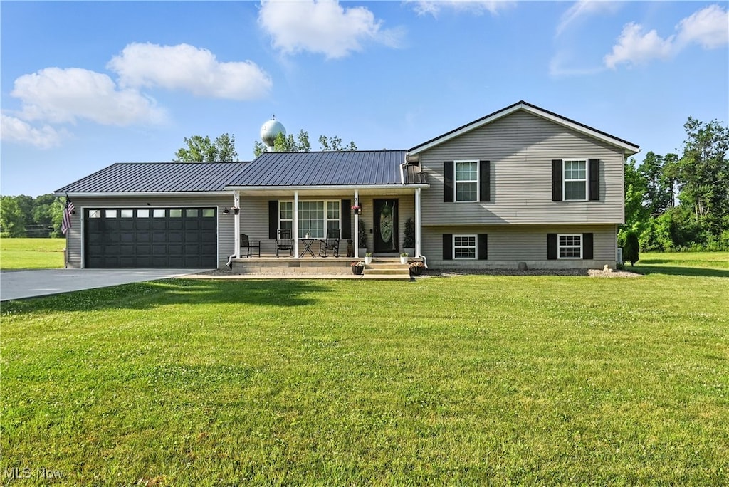 7326 State Route 19, Mount Gilead, OH 43338 - tri-level home with a porch, an attached garage, driveway, a front yard, and a metal roof