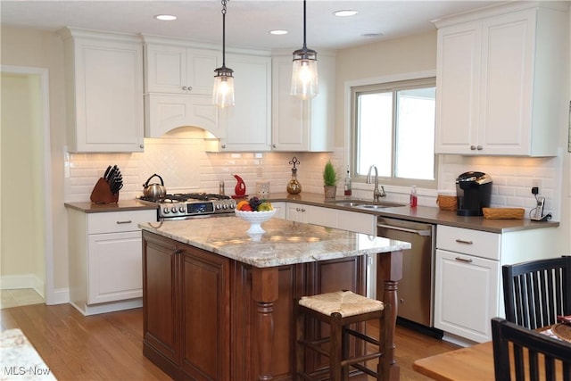 31382 Saint Andrews, Westlake, OH 44145 - kitchen with appliances with stainless steel finishes, white cabinets, a kitchen island, and recessed lighting